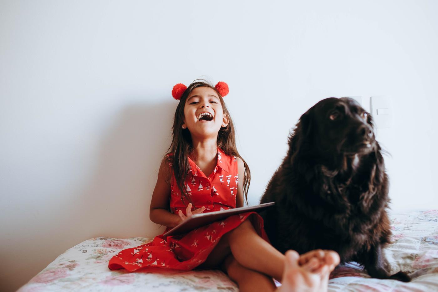 Girl. Dog. Red dress. Closeup. 